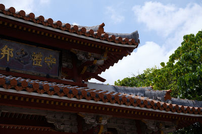 Low angle view of temple and building against sky