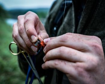 Midsection of man holding equipment