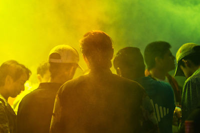 Rear view of people enjoying at music concert