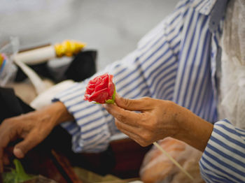 Midsection of man holding ice cream