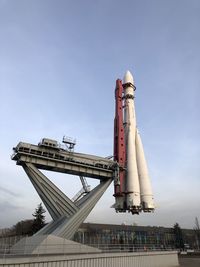 Low angle view of crane against sky