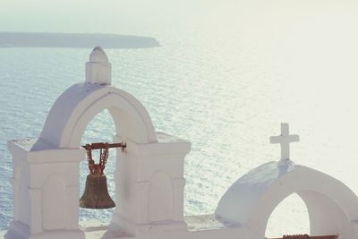 Built structure by sea against sky