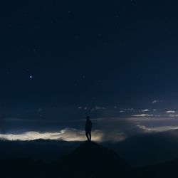 Silhouette of woman standing by tree