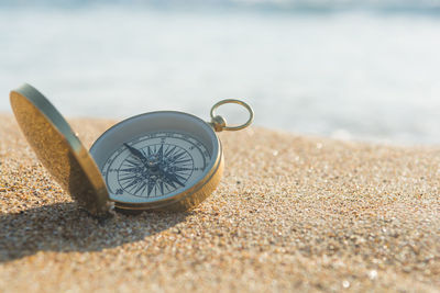 Close-up of sunglasses on beach