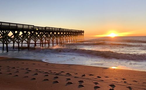 Scenic view of beach against sky during sunset