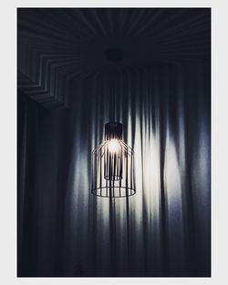 Close-up of illuminated lamp hanging on wall