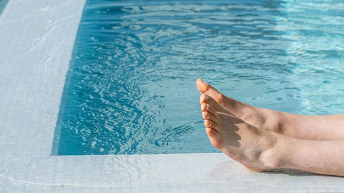 Low section of person in swimming pool