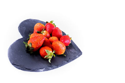 High angle view of strawberries in bowl against white background