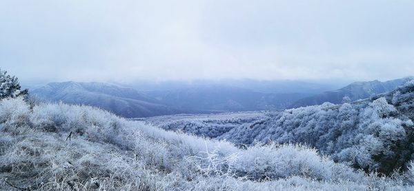 Scenic view of mountains against sky during winter