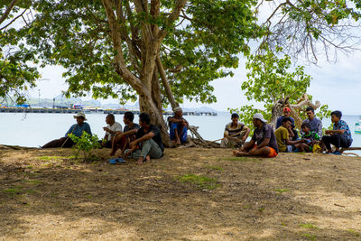 Group of people relaxing on shore