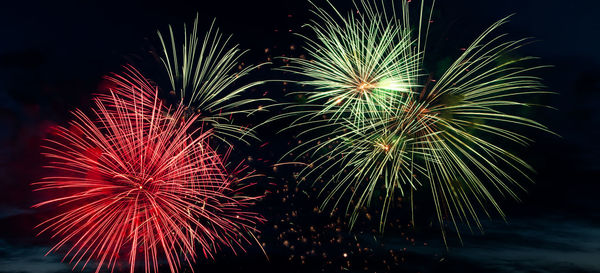 Low angle view of firework display at night