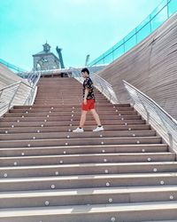Full length of woman walking on boardwalk