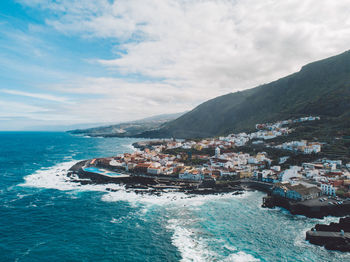 Scenic view of sea and buildings against sky