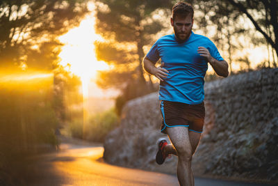 Young man jogging on road