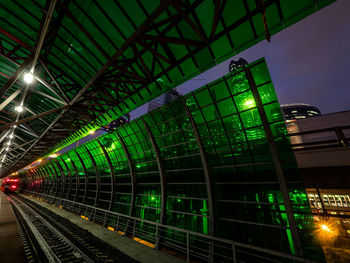 Illuminated railroad station platform against sky