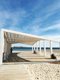 View of pier on beach against sky