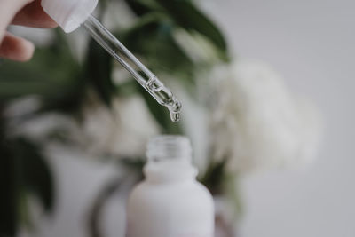 Close-up of hand holding bottle