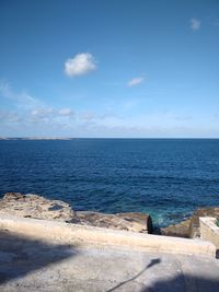 Scenic view of sea against blue sky