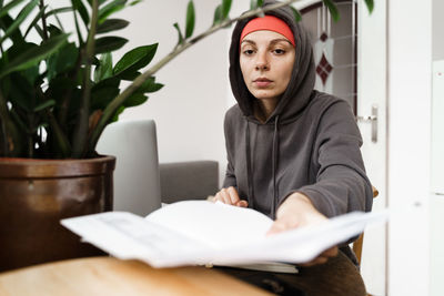 Portrait of young woman reading book