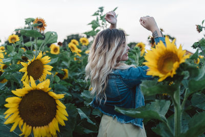 Full length of woman standing on sunflower