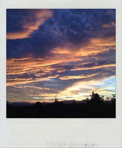 Silhouette of landscape against cloudy sky