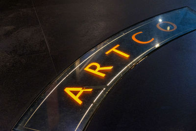 High angle view of information sign on car at night