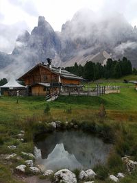 Built structure by lake against sky