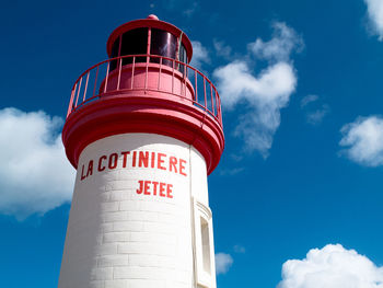 Low angle view of lighthouse against blue sky