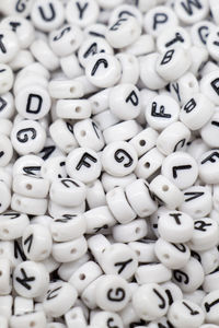 Full frame shot of beads with alphabets