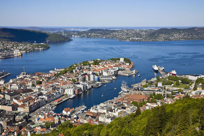 High angle view of townscape by sea against sky