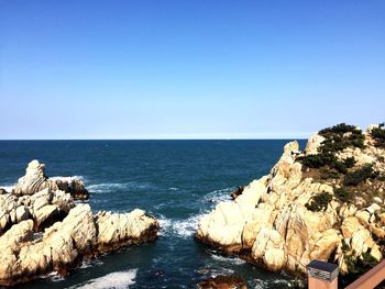 Scenic view of sea against clear blue sky