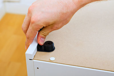 Cropped hand of person holding equipment