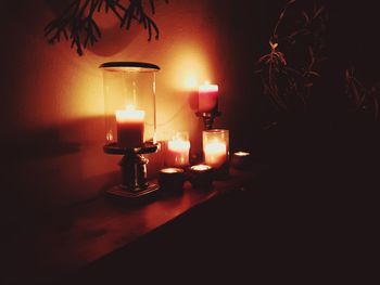 Close-up of illuminated candles on table