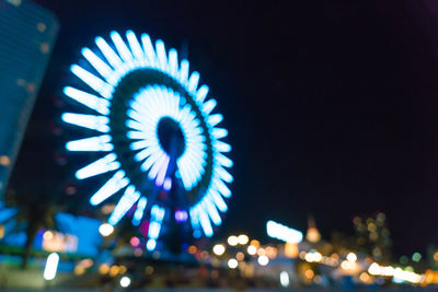 Low angle view of illuminated ferris wheel at night