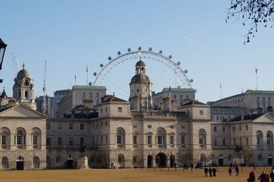 Buildings in city against clear sky