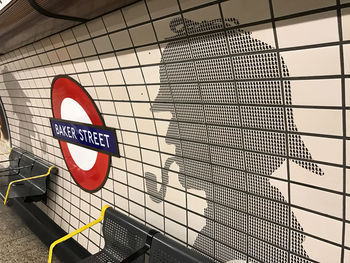 Low angle view of road sign against metal