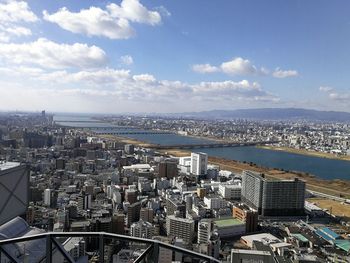 High angle view of buildings by sea against sky