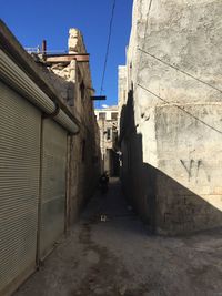 Alley amidst buildings against sky