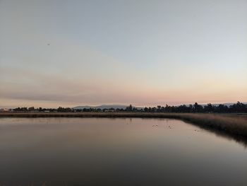 Scenic view of lake against sky during sunset