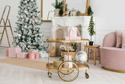 Transfer cart with christmas decor and gifts in the interior of a classic living room