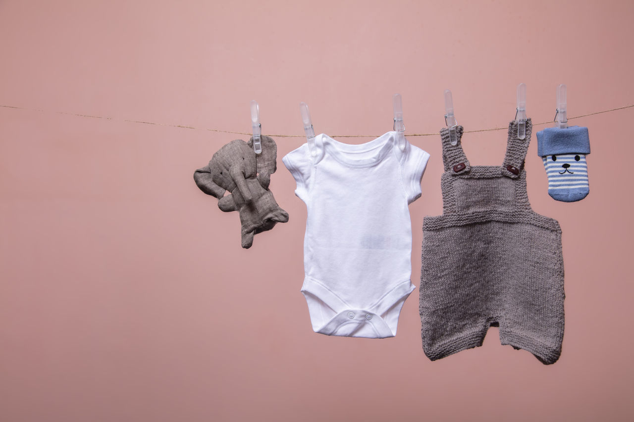 CLOSE-UP OF CLOTHES DRYING AGAINST WALL