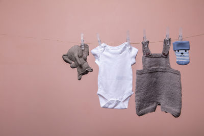 Close-up of clothes drying on clothesline against wall