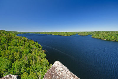 Scenic view of land against clear blue sky