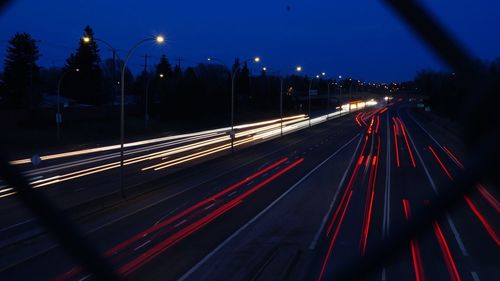 High angle view of light trails on road at night