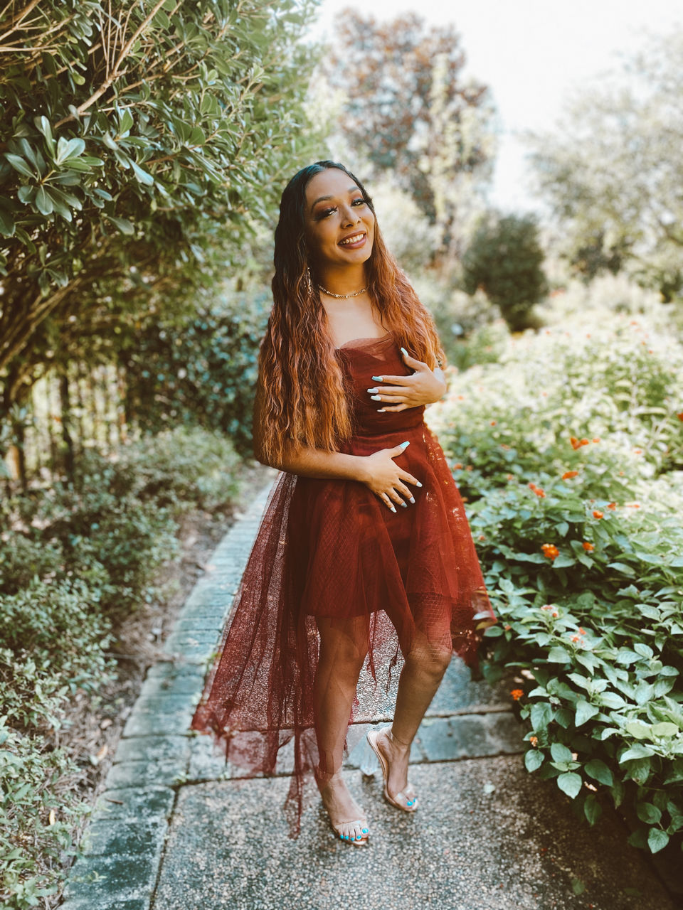 women, long hair, one person, hairstyle, adult, young adult, fashion, clothing, plant, nature, dress, portrait, tree, full length, spring, photo shoot, smiling, brown hair, happiness, looking, standing, autumn, outdoors, beauty in nature, lifestyles, female, emotion, elegance, redhead, leisure activity, looking at camera, front view, forest, flower, day, summer, land, contemplation, cheerful, arts culture and entertainment, flowering plant
