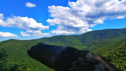 Scenic view of mountains against cloudy sky