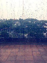 Raindrops on glass window in city