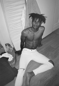 Portrait of young man sitting at home