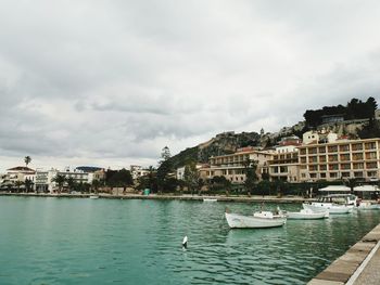 View of buildings in city against cloudy sky