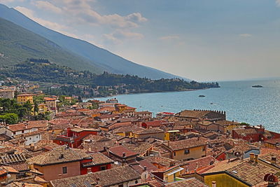 High angle view of townscape by sea against sky